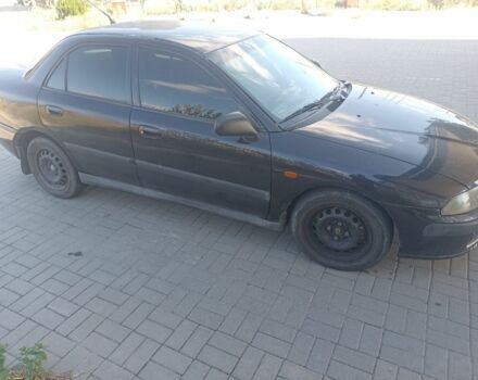 Черный Мицубиси Харизма, объемом двигателя 1.6 л и пробегом 402 тыс. км за 2200 $, фото 2 на Automoto.ua