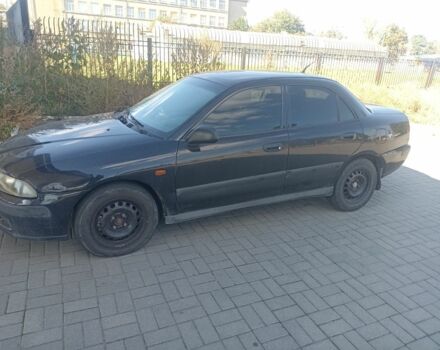 Черный Мицубиси Харизма, объемом двигателя 1.6 л и пробегом 402 тыс. км за 2200 $, фото 1 на Automoto.ua