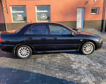 Черный Мицубиси Харизма, объемом двигателя 1.6 л и пробегом 30 тыс. км за 3000 $, фото 1 на Automoto.ua