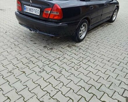 Черный Мицубиси Харизма, объемом двигателя 1.6 л и пробегом 140 тыс. км за 3500 $, фото 1 на Automoto.ua