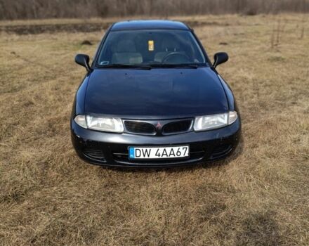 Черный Мицубиси Харизма, объемом двигателя 1.9 л и пробегом 300 тыс. км за 1580 $, фото 1 на Automoto.ua