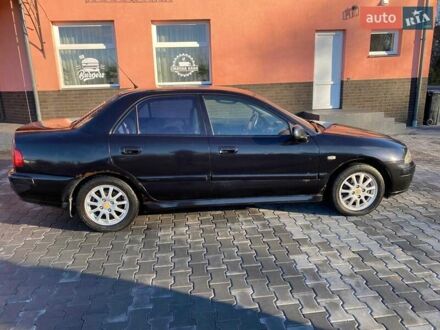 Черный Мицубиси Харизма, объемом двигателя 1.6 л и пробегом 30 тыс. км за 3000 $, фото 1 на Automoto.ua