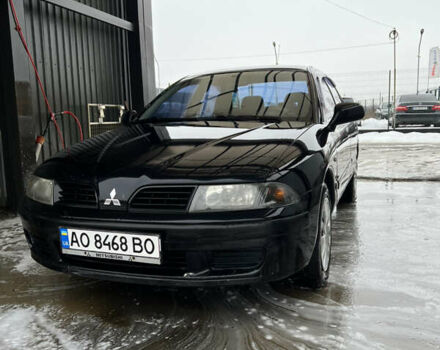 Черный Мицубиси Харизма, объемом двигателя 1.6 л и пробегом 300 тыс. км за 3100 $, фото 1 на Automoto.ua