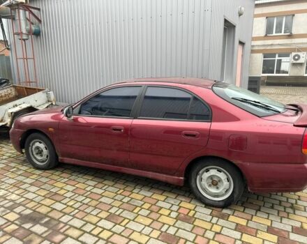 Красный Мицубиси Харизма, объемом двигателя 1.8 л и пробегом 200 тыс. км за 800 $, фото 1 на Automoto.ua