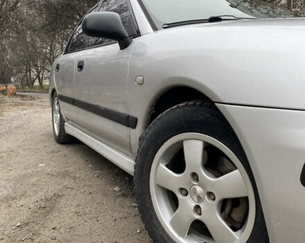 Сірий Міцубісі Харизма, об'ємом двигуна 1.83 л та пробігом 265 тис. км за 2850 $, фото 1 на Automoto.ua