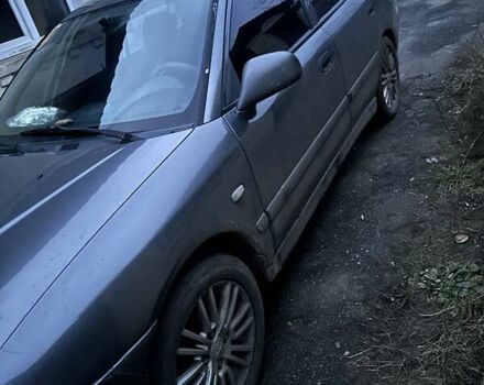 Серый Мицубиси Харизма, объемом двигателя 1.6 л и пробегом 380 тыс. км за 3087 $, фото 1 на Automoto.ua