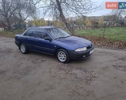 Синий Мицубиси Харизма, объемом двигателя 1.83 л и пробегом 205 тыс. км за 2100 $, фото 1 на Automoto.ua