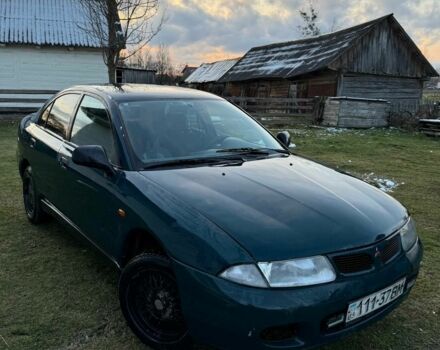 Зеленый Мицубиси Харизма, объемом двигателя 1 л и пробегом 475 тыс. км за 1299 $, фото 1 на Automoto.ua