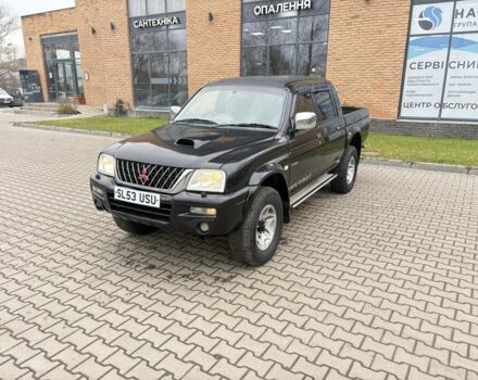 Черный Мицубиси Л 200, объемом двигателя 2.5 л и пробегом 167 тыс. км за 6647 $, фото 1 на Automoto.ua
