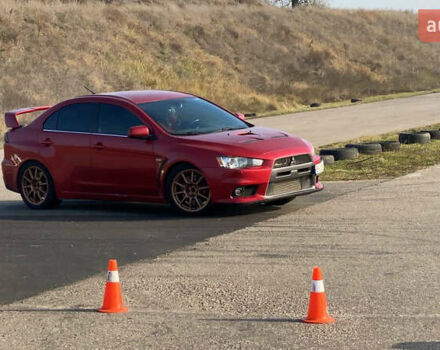 Красный Мицубиси Лансер Эволюшн, объемом двигателя 2 л и пробегом 115 тыс. км за 18000 $, фото 3 на Automoto.ua