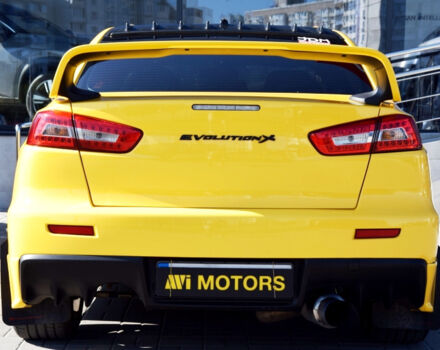 Жовтий Міцубісі Лансер Еволюшн, об'ємом двигуна 2 л та пробігом 180 тис. км за 24999 $, фото 5 на Automoto.ua
