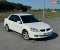 Белый Мицубиси Лансер, объемом двигателя 1.58 л и пробегом 250 тыс. км за 4999 $, фото 1 на Automoto.ua
