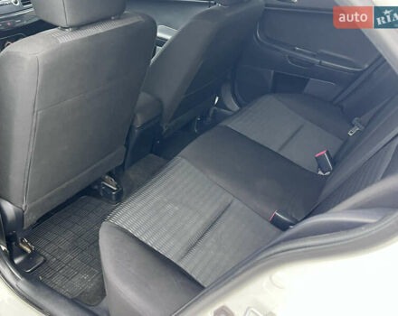 Белый Мицубиси Лансер, объемом двигателя 1.59 л и пробегом 145 тыс. км за 7500 $, фото 11 на Automoto.ua