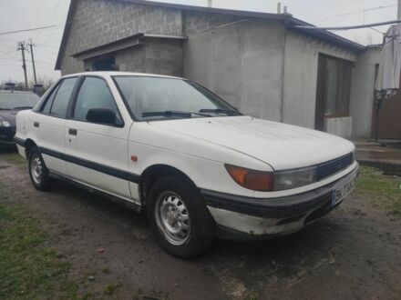 Белый Мицубиси Лансер, объемом двигателя 1.5 л и пробегом 240 тыс. км за 850 $, фото 1 на Automoto.ua