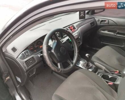 Черный Мицубиси Лансер, объемом двигателя 1.58 л и пробегом 265 тыс. км за 2600 $, фото 1 на Automoto.ua