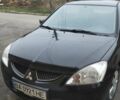 Черный Мицубиси Лансер, объемом двигателя 1.58 л и пробегом 240 тыс. км за 3700 $, фото 1 на Automoto.ua