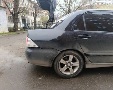 Черный Мицубиси Лансер, объемом двигателя 2 л и пробегом 275 тыс. км за 2599 $, фото 2 на Automoto.ua