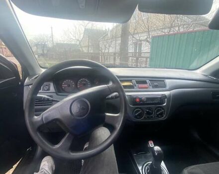 Чорний Міцубісі Lancer, об'ємом двигуна 1.58 л та пробігом 279 тис. км за 4000 $, фото 7 на Automoto.ua