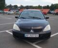 Черный Мицубиси Лансер, объемом двигателя 1.58 л и пробегом 241 тыс. км за 3000 $, фото 1 на Automoto.ua