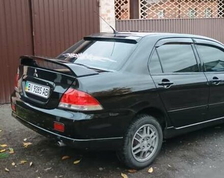 Черный Мицубиси Лансер, объемом двигателя 1.58 л и пробегом 261 тыс. км за 4400 $, фото 7 на Automoto.ua