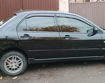 Черный Мицубиси Лансер, объемом двигателя 1.58 л и пробегом 261 тыс. км за 4400 $, фото 3 на Automoto.ua