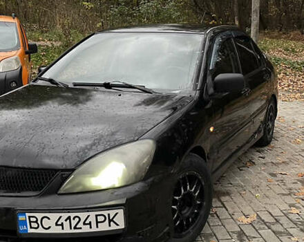 Черный Мицубиси Лансер, объемом двигателя 1.6 л и пробегом 200 тыс. км за 3000 $, фото 1 на Automoto.ua