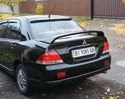 Черный Мицубиси Лансер, объемом двигателя 1.58 л и пробегом 261 тыс. км за 4400 $, фото 5 на Automoto.ua