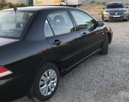 Черный Мицубиси Лансер, объемом двигателя 1.58 л и пробегом 161 тыс. км за 4800 $, фото 5 на Automoto.ua