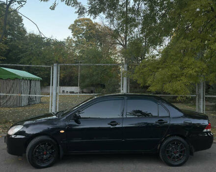 Черный Мицубиси Лансер, объемом двигателя 1.6 л и пробегом 233 тыс. км за 3650 $, фото 1 на Automoto.ua