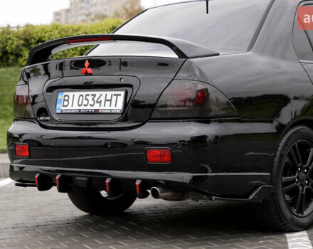 Черный Мицубиси Лансер, объемом двигателя 2 л и пробегом 253 тыс. км за 6900 $, фото 4 на Automoto.ua