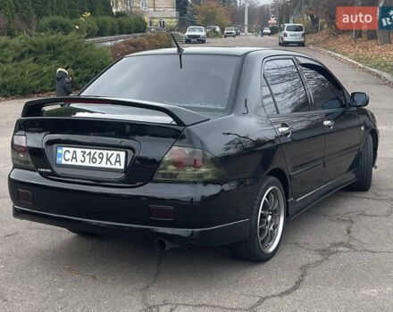 Чорний Міцубісі Lancer, об'ємом двигуна 2 л та пробігом 242 тис. км за 5900 $, фото 3 на Automoto.ua
