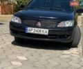 Черный Мицубиси Лансер, объемом двигателя 1.6 л и пробегом 300 тыс. км за 4000 $, фото 1 на Automoto.ua
