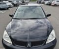 Чорний Міцубісі Lancer, об'ємом двигуна 1.58 л та пробігом 319 тис. км за 2500 $, фото 1 на Automoto.ua