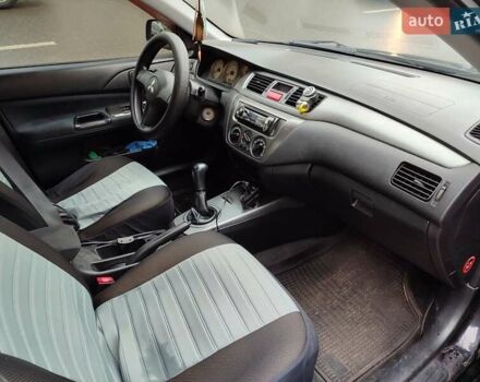 Черный Мицубиси Лансер, объемом двигателя 1.58 л и пробегом 270 тыс. км за 4000 $, фото 2 на Automoto.ua