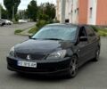 Черный Мицубиси Лансер, объемом двигателя 2 л и пробегом 311 тыс. км за 4500 $, фото 1 на Automoto.ua