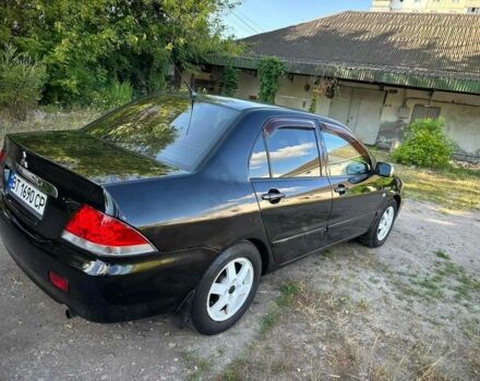 Черный Мицубиси Лансер, объемом двигателя 1.6 л и пробегом 289 тыс. км за 3200 $, фото 1 на Automoto.ua