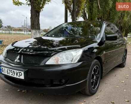 Чорний Міцубісі Lancer, об'ємом двигуна 1.58 л та пробігом 386 тис. км за 4450 $, фото 1 на Automoto.ua