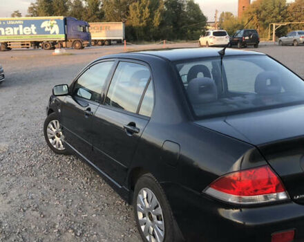 Черный Мицубиси Лансер, объемом двигателя 1.58 л и пробегом 161 тыс. км за 4800 $, фото 3 на Automoto.ua