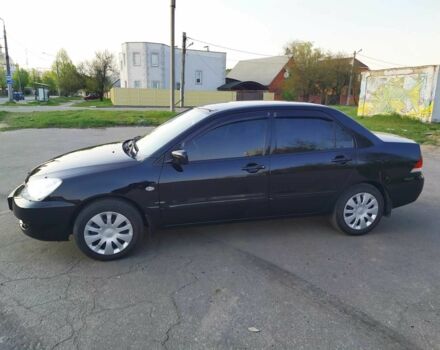 Черный Мицубиси Лансер, объемом двигателя 1.6 л и пробегом 32 тыс. км за 9000 $, фото 2 на Automoto.ua