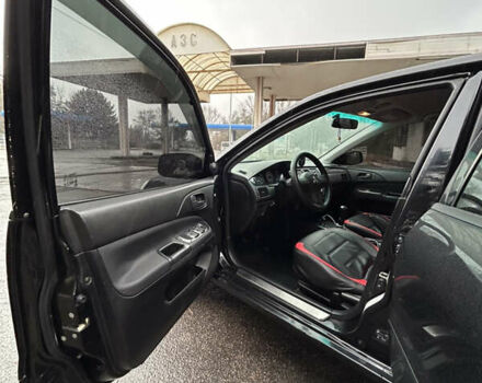 Черный Мицубиси Лансер, объемом двигателя 1.58 л и пробегом 254 тыс. км за 5000 $, фото 14 на Automoto.ua