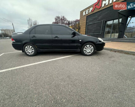 Черный Мицубиси Лансер, объемом двигателя 1.58 л и пробегом 290 тыс. км за 3000 $, фото 6 на Automoto.ua