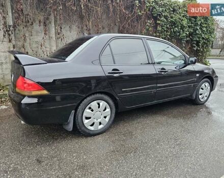 Черный Мицубиси Лансер, объемом двигателя 1.6 л и пробегом 152 тыс. км за 4999 $, фото 1 на Automoto.ua