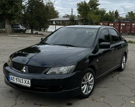 Черный Мицубиси Лансер, объемом двигателя 2 л и пробегом 143 тыс. км за 4999 $, фото 1 на Automoto.ua