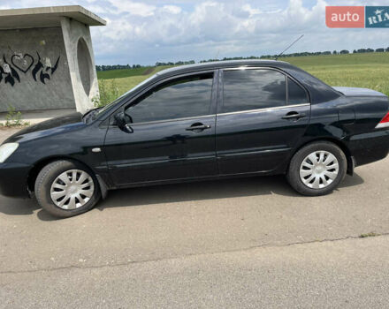 Черный Мицубиси Лансер, объемом двигателя 1.59 л и пробегом 150 тыс. км за 5500 $, фото 7 на Automoto.ua