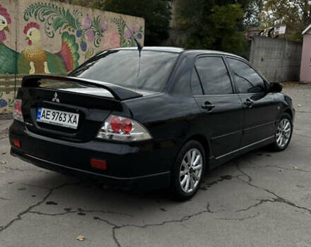 Черный Мицубиси Лансер, объемом двигателя 2 л и пробегом 143 тыс. км за 4999 $, фото 3 на Automoto.ua
