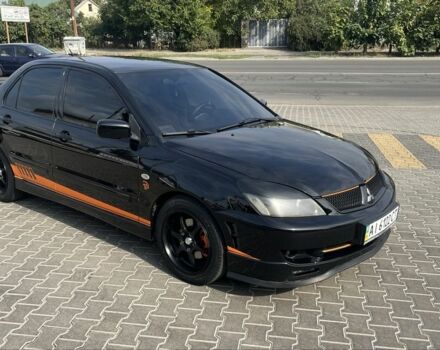 Черный Мицубиси Лансер, объемом двигателя 2 л и пробегом 224 тыс. км за 5800 $, фото 1 на Automoto.ua