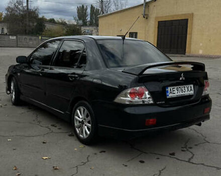 Черный Мицубиси Лансер, объемом двигателя 2 л и пробегом 143 тыс. км за 4999 $, фото 2 на Automoto.ua