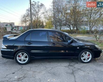 Черный Мицубиси Лансер, объемом двигателя 2 л и пробегом 280 тыс. км за 5400 $, фото 3 на Automoto.ua