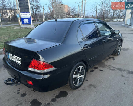 Черный Мицубиси Лансер, объемом двигателя 1.6 л и пробегом 315 тыс. км за 4000 $, фото 1 на Automoto.ua