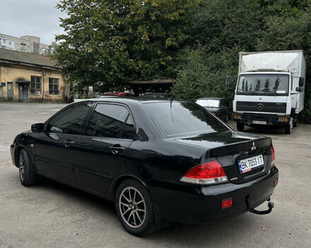 Чорний Міцубісі Lancer, об'ємом двигуна 1.58 л та пробігом 256 тис. км за 4200 $, фото 4 на Automoto.ua